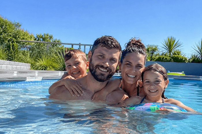 Family enjoying a clean, freshly painted swimming pool in New Zealand