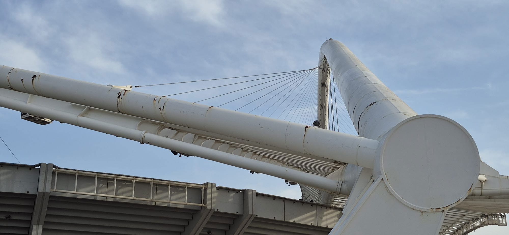 The Athens Olympic Stadium arches before coating, showing corrosion staining on the white steelwork