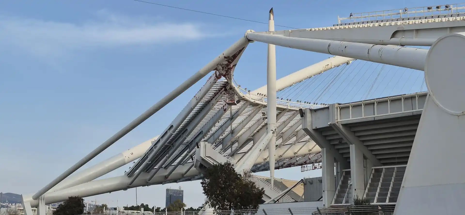 First coat of Noxyde Plus in RAL 7305 light grey being applied across the stadium structure