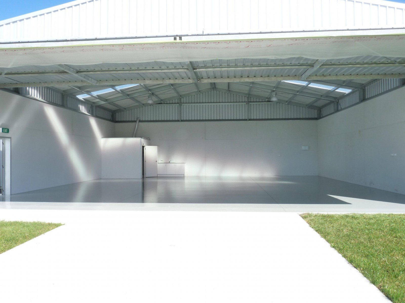 Aircraft hangar with a freshly coated high gloss epoxy concrete floor